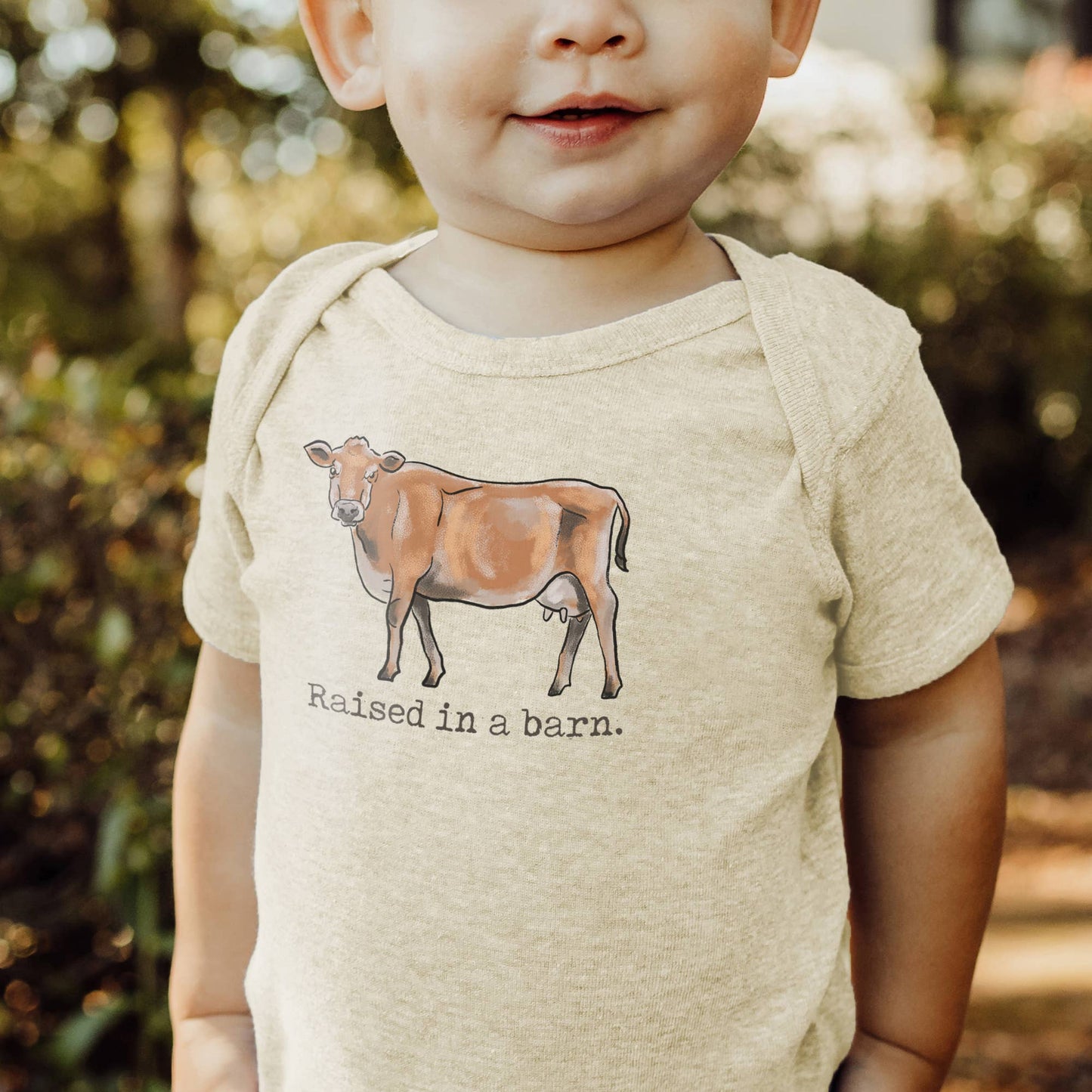 Raised in a Barn Country Western Baby Onesie [Natural]